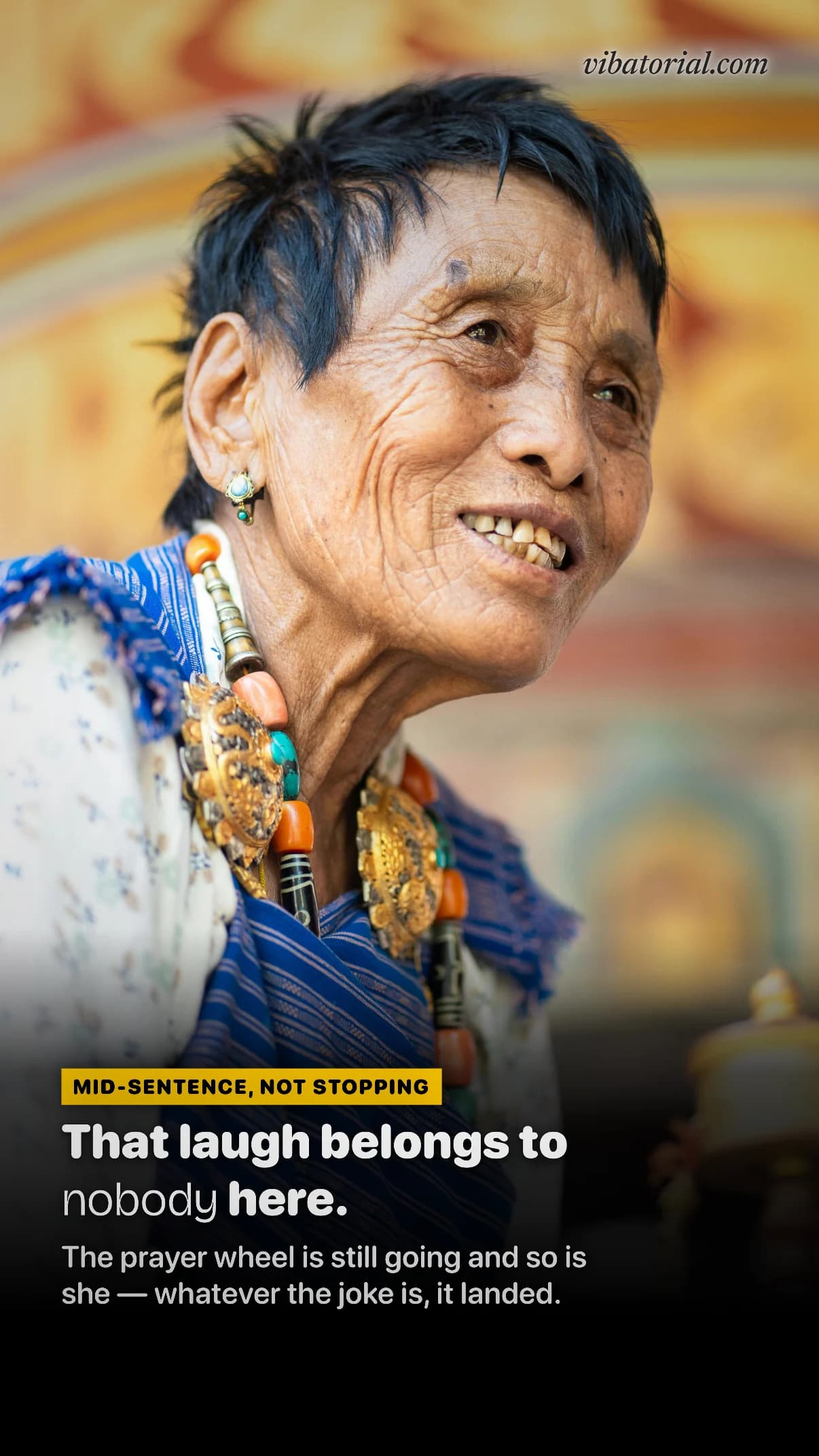 Magazine cover made by Vibatorial from a photo of an older woman laughing, holding a prayer wheel. Headline: That laugh belongs to nobody here.